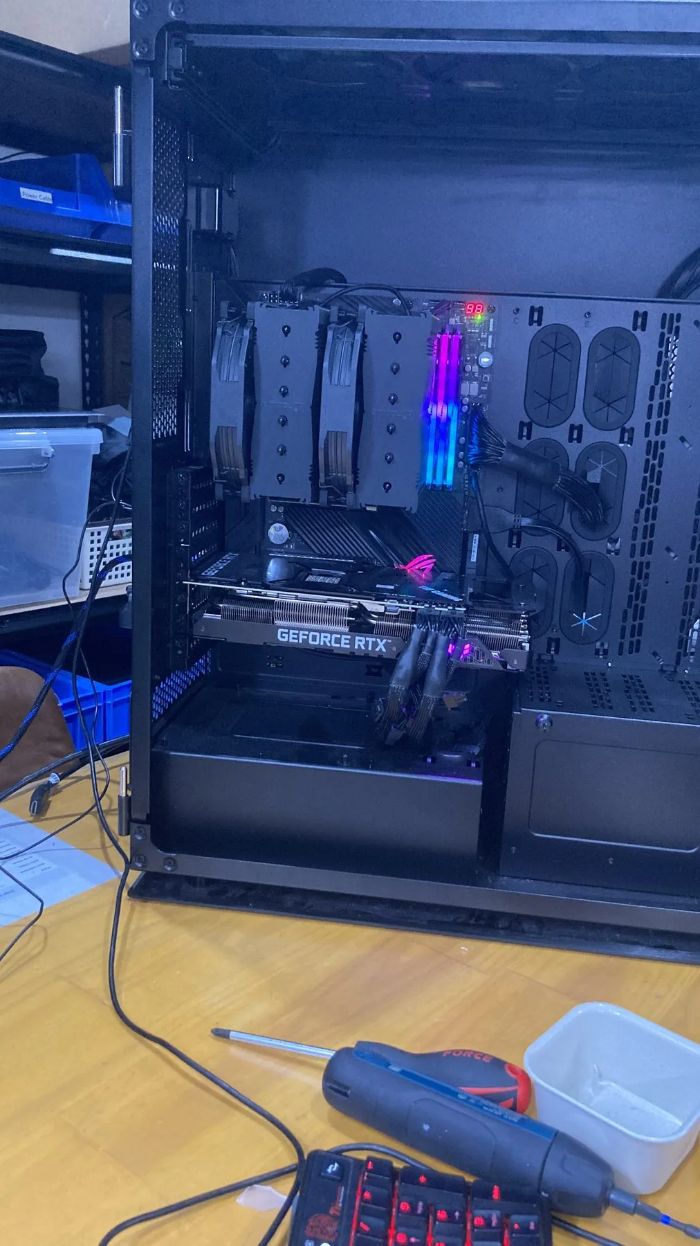 A custom-built desktop PC with the side panel off, showing the graphics card and cabling