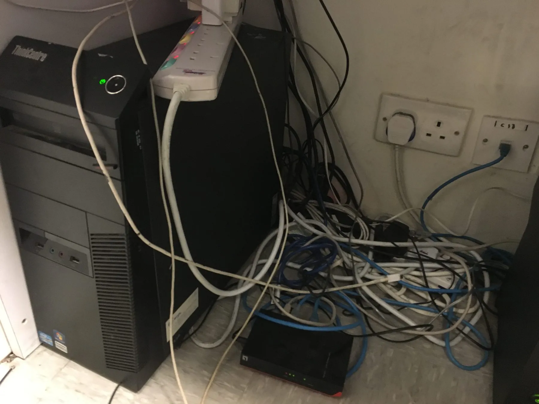 A desktop tower being serviced on site beneath an office desk